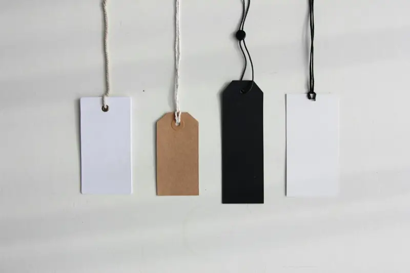 Four blank white paper tags