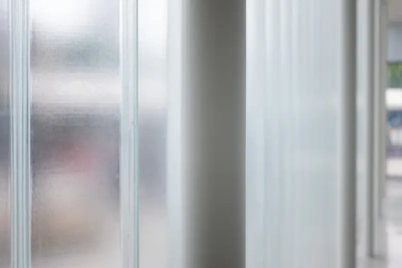 A frosted glass corridor that lets light through but not shapes