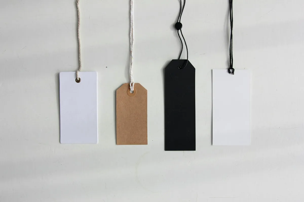 Four blank white paper tags